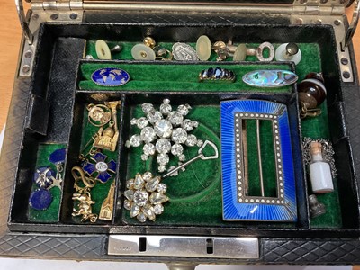 Lot 105 - Jewellery box containing a silver and blue enamel buckle, paste set brooches, white metal figural panel necklace, various gilt metal charms