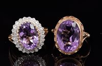 Lot 626 - Amethyst and diamond cluster ring with an oval...