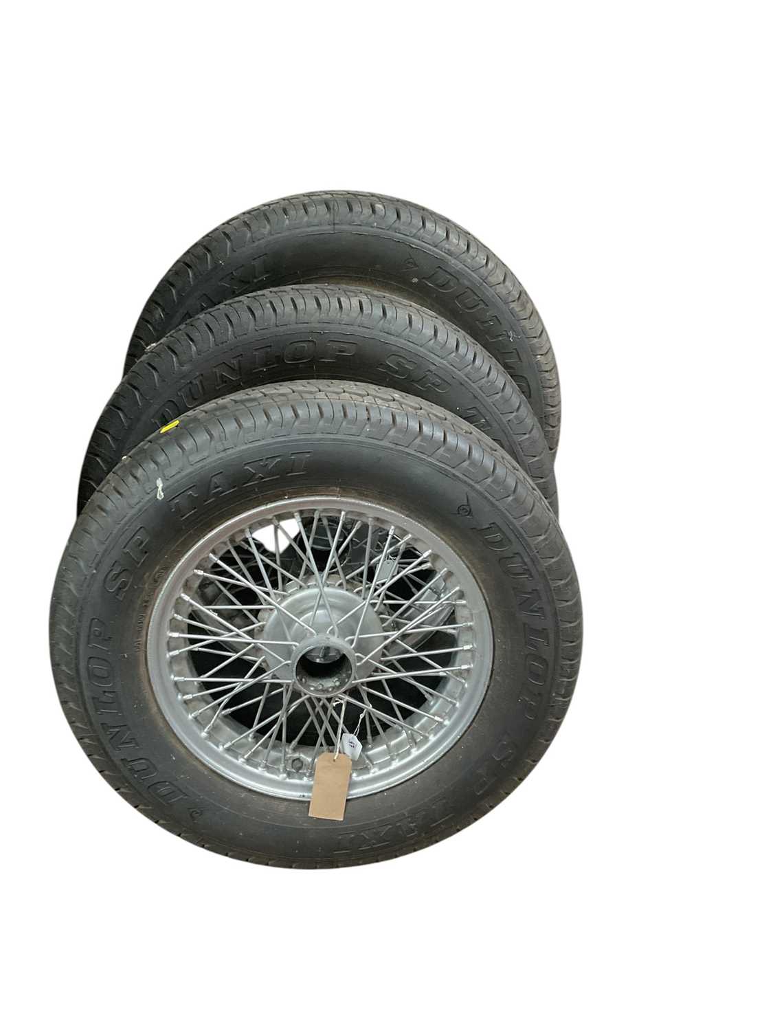 Lot 47 - Group of three silver painted wire wheels and tyres, believed to suit MG TC / TA models (3).