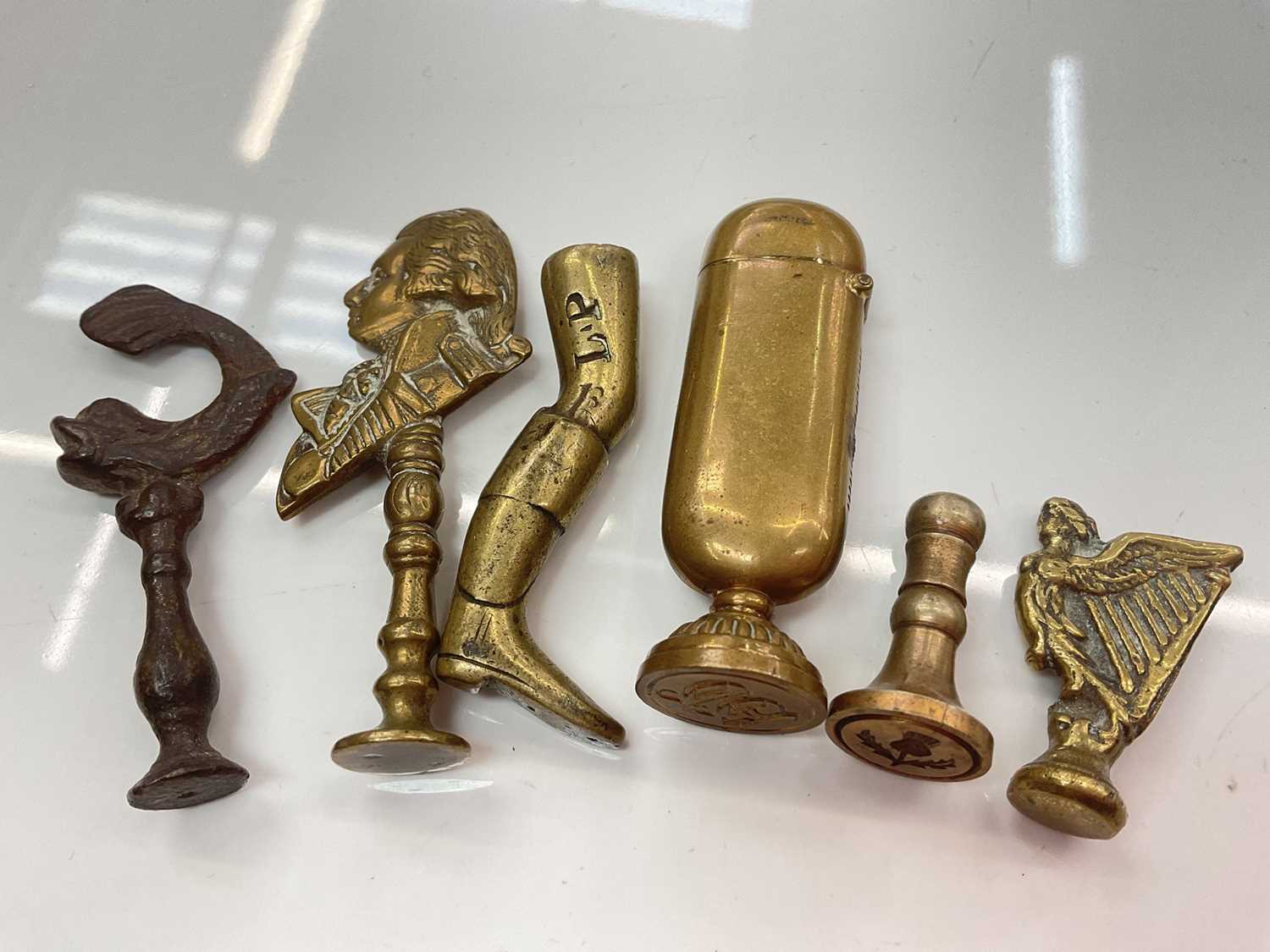 Lot 386 - Collection of brass pipe tampers and desk seals including 18th century and later examples and a combination desk seal vesta