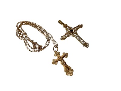 Lot 60 - Gold (585) crucifix pendant on gold (585) chain, together with a yellow metal filigree cross pendant