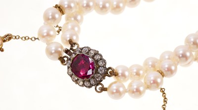 Lot 488 - Cultured pearl two-strand necklace on an antique ruby and diamond cluster clasp