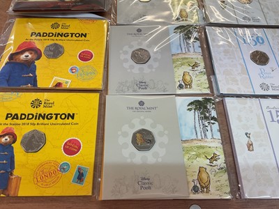 Lot 493 - G.B. - Royal Mint uncirculated flatpack coins to include Fifty Pence Beatrix Potter x 14, Classic Pooh x 4, Paddington Bear x 2, Beatrix Potter Treasure of Life coin collection album 2017 (N.B....