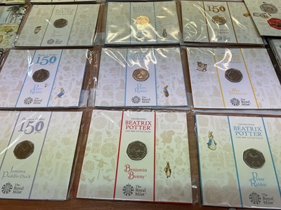 Lot 493 - G.B. - Royal Mint uncirculated flatpack coins to include Fifty Pence Beatrix Potter x 14, Classic Pooh x 4, Paddington Bear x 2, Beatrix Potter Treasure of Life coin collection album 2017 (N.B....