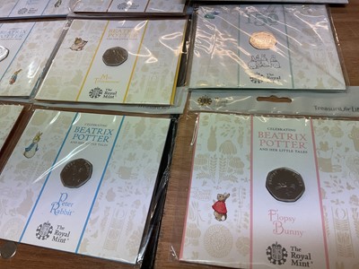 Lot 493 - G.B. - Royal Mint uncirculated flatpack coins to include Fifty Pence Beatrix Potter x 14, Classic Pooh x 4, Paddington Bear x 2, Beatrix Potter Treasure of Life coin collection album 2017 (N.B....
