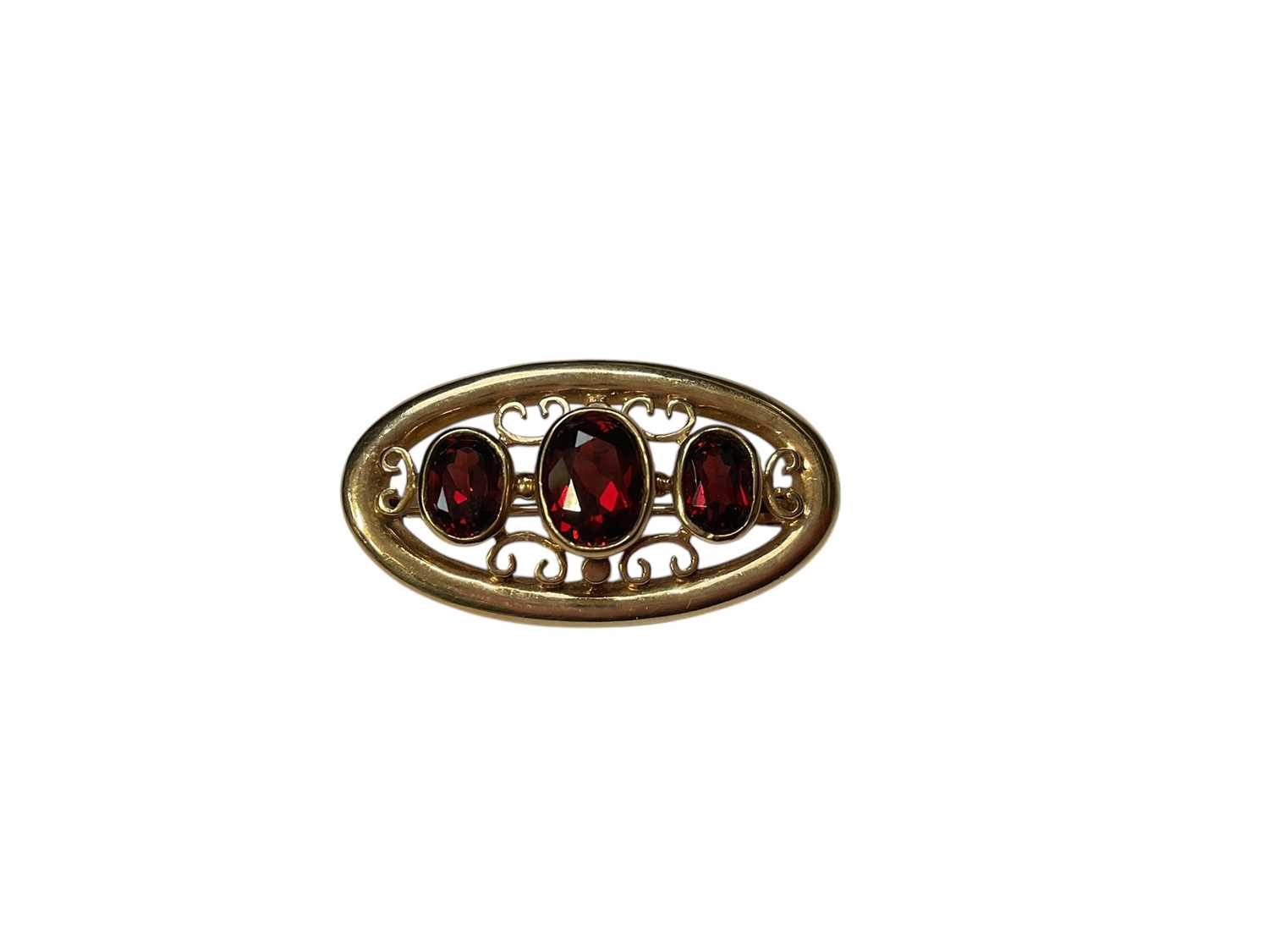 Lot 178 - 9ct gold garnet three stone oval brooch