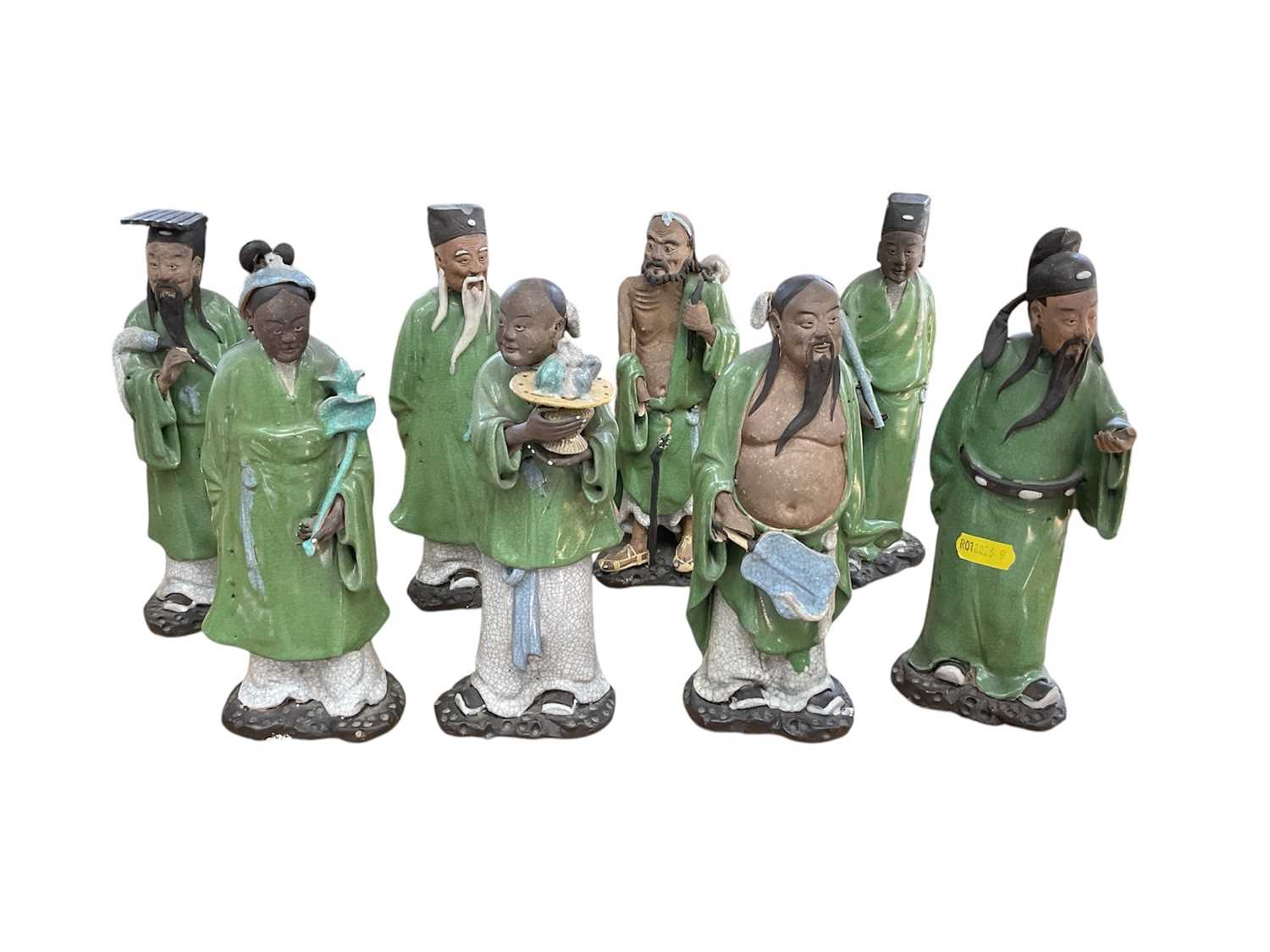 Lot 63 - Eight Chinese pottery figures of Immortals