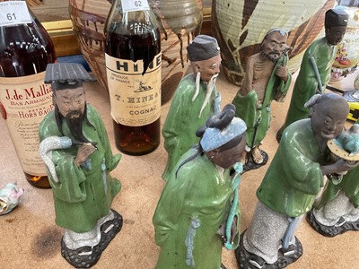 Lot 63 - Eight Chinese pottery figures of Immortals