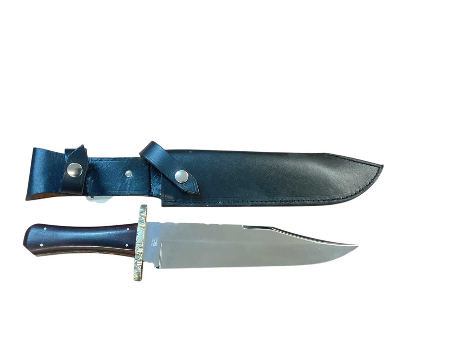 Lot 873 - Large Bowie knife by Graham Clayton with 24.6cm blade, clip back point with false edge, worked back, cut and engraved cross guard, milled brass liners and cocobolo wood scales with inlaid white...