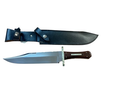 Lot 873 - Large Bowie knife by Graham Clayton with 24.6cm blade, clip back point with false edge, worked back, cut and engraved cross guard, milled brass liners and cocobolo wood scales with inlaid white...