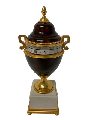 Lot 736 - Modern Louis XVI style urn shaped clock, by Hour Lavigne, brown lacquered and gilt, on a marble base, with horizontal rotating dial, 35cm high