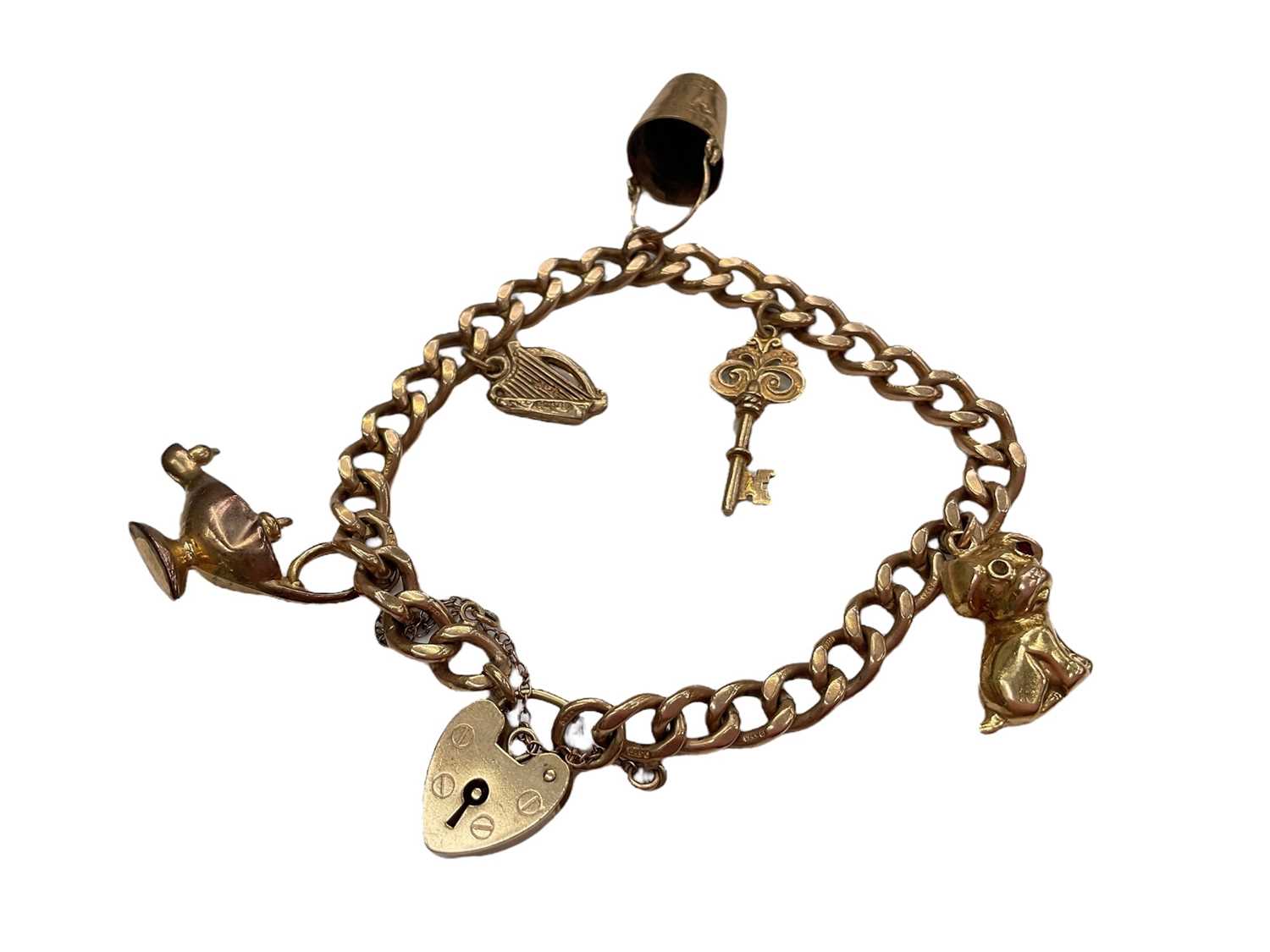 Lot 1001 - 9ct gold curb link charm bracelet