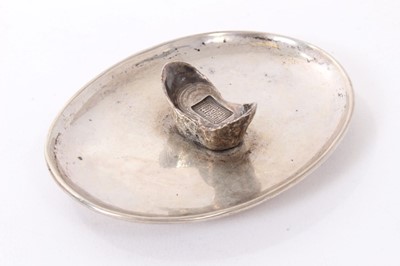 Lot 192 - Chinese silver dish of dished oval form on an oval base and mounted with a Chinese boat shaped silver Sycee ingot, underside with label referring to late 1920s. All at approximately 3ozs. 11cm a...