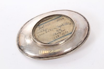 Lot 192 - Chinese silver dish of dished oval form on an oval base and mounted with a Chinese boat shaped silver Sycee ingot, underside with label referring to late 1920s. All at approximately 3ozs. 11cm a...