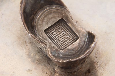 Lot 192 - Chinese silver dish of dished oval form on an oval base and mounted with a Chinese boat shaped silver Sycee ingot, underside with label referring to late 1920s. All at approximately 3ozs. 11cm a...