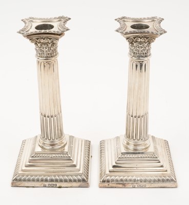 Lot 254 - Pair of silver Corinthian column candlesticks