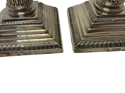 Lot 254 - Pair of silver Corinthian column candlesticks