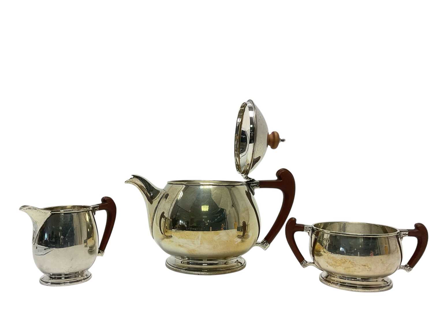 Lot 257 - Stylish Art Deco silver three piece tea set with Bakelite handles