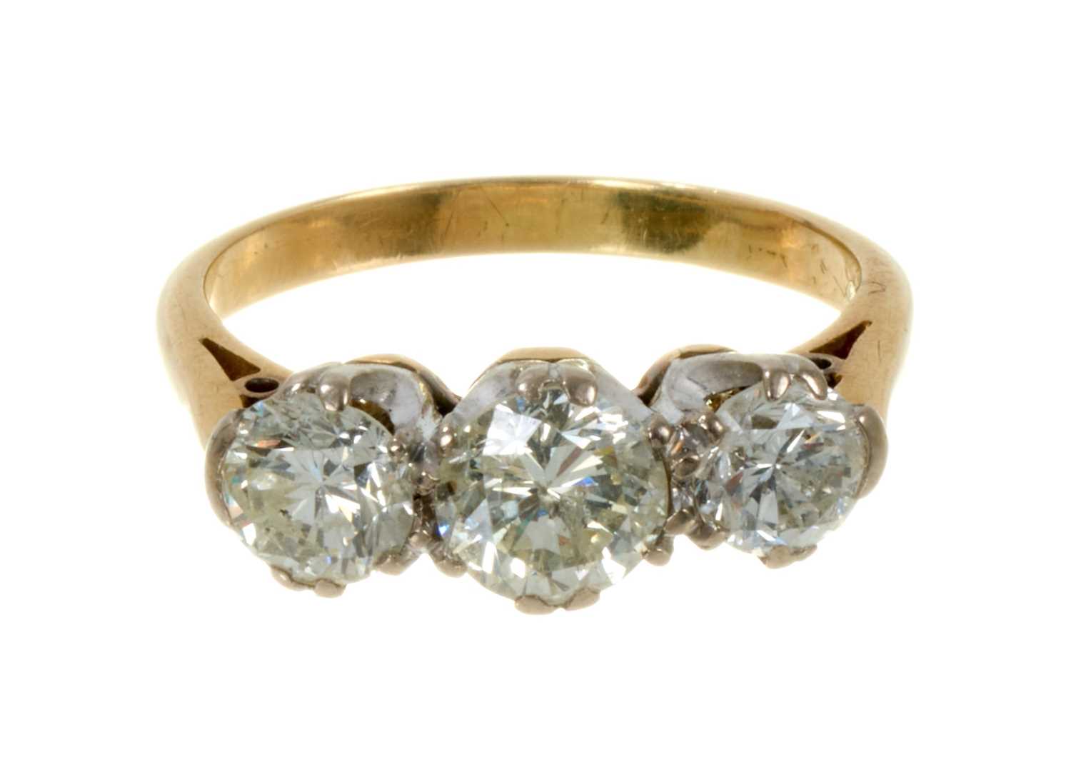 Lot 497 - Diamond three stone ring with three brilliant cut diamonds in platinum claw setting on gold shank