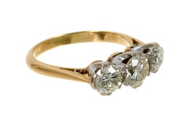 Lot 497 - Diamond three stone ring with three brilliant cut diamonds in platinum claw setting on gold shank