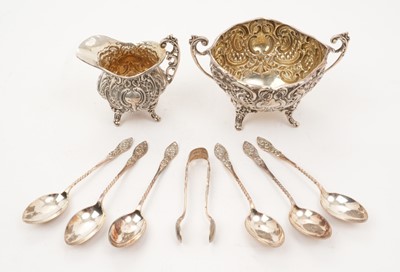 Lot 260 - Late Victorian silver sugar and cream set, with scroll and latticework decoration