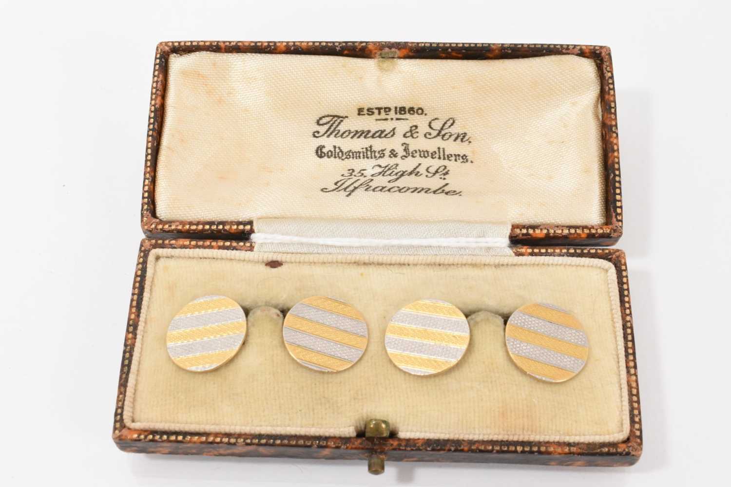 Lot 473 - Pair of 1920s platinum and 18ct yellow gold cufflinks with engine turned decoration
