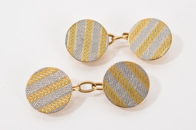 Lot 473 - Pair of 1920s platinum and 18ct yellow gold cufflinks with engine turned decoration
