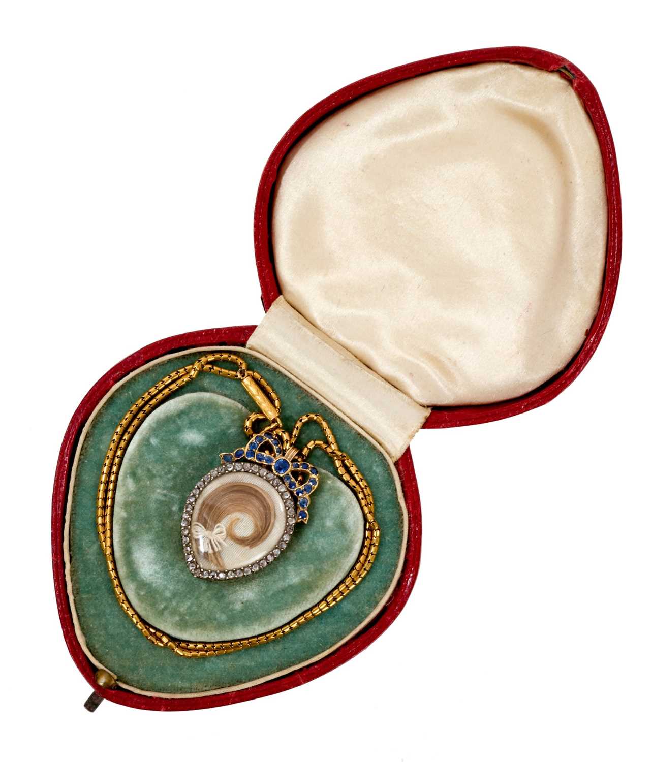 Lot 475 - Edwardian heart shaped double sided locket in diamond frame with sapphire ribbon surmount, on chain