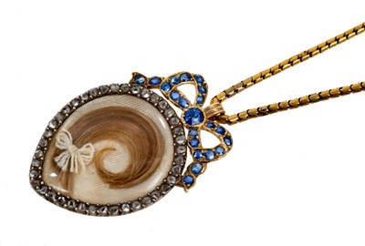 Lot 475 - Edwardian heart shaped double sided locket in diamond frame with sapphire ribbon surmount, on chain