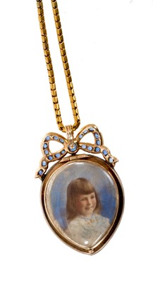 Lot 475 - Edwardian heart shaped double sided locket in diamond frame with sapphire ribbon surmount, on chain
