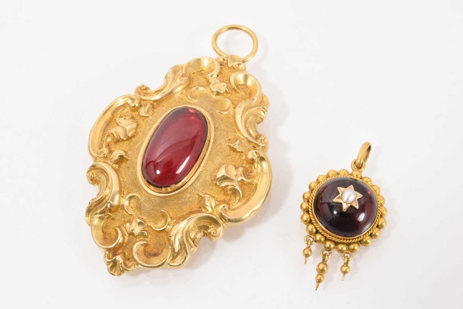 Lot 480 - Two Victorian cabochon garnet pendants