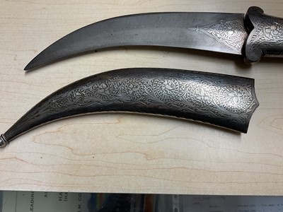 Lot 138 - Good quality 20th century Indian ceremonial dagger with silver inlaid scabbard, grip and elephant head pommel, with curved Damascus steel blade, blade 24cm in length.