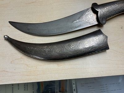 Lot 138 - Good quality 20th century Indian ceremonial dagger with silver inlaid scabbard, grip and elephant head pommel, with curved Damascus steel blade, blade 24cm in length.