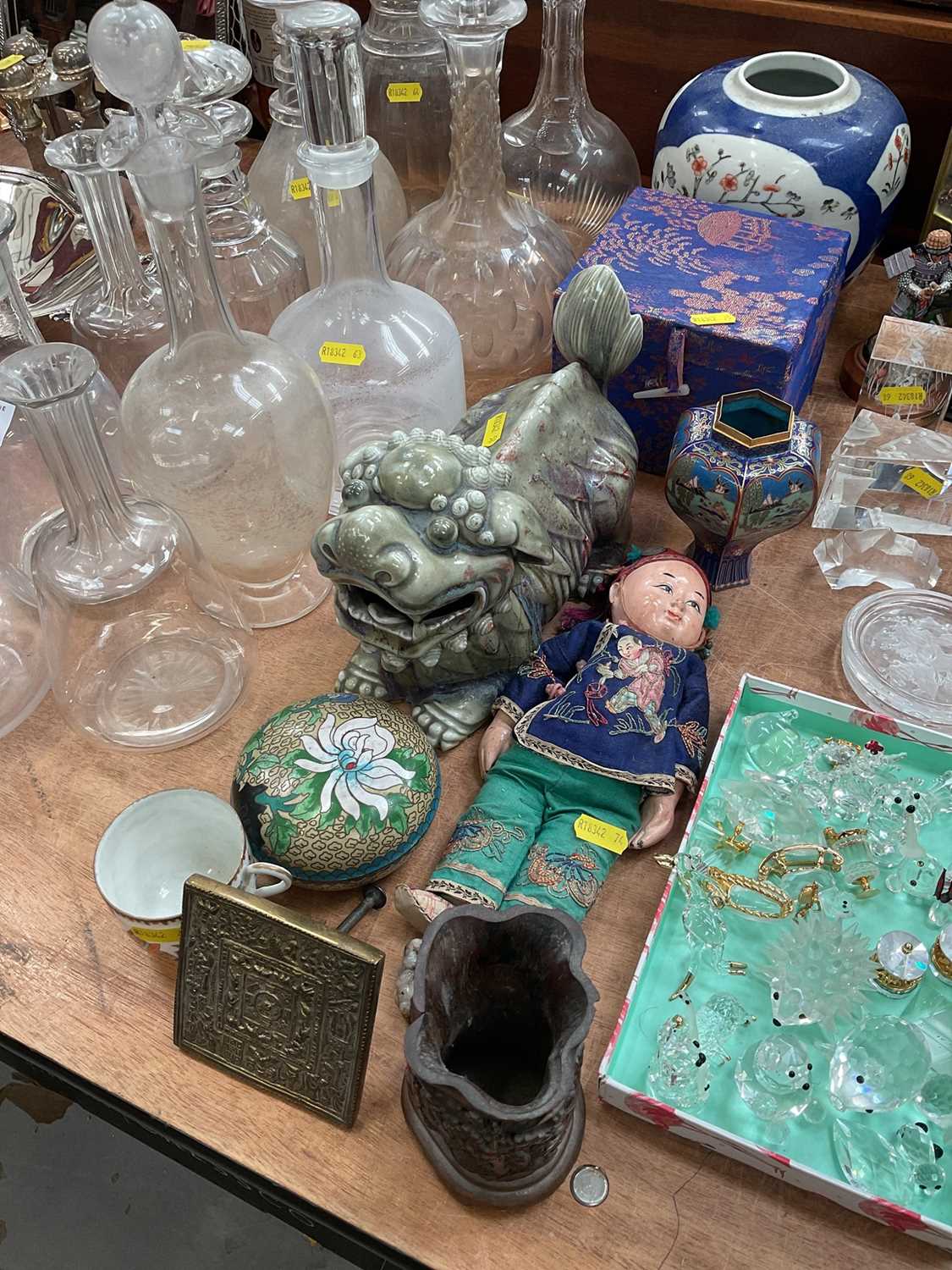 Lot 594 - Chinese ceramic celadon dog of foo, Chinese small doll with embroidered clothes, Chinese small teapot, a cloisonné small vase, two dishes and other oriental items.