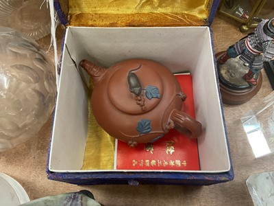 Lot 594 - Chinese ceramic celadon dog of foo, Chinese small doll with embroidered clothes, Chinese small teapot, a cloisonné small vase, two dishes and other oriental items.
