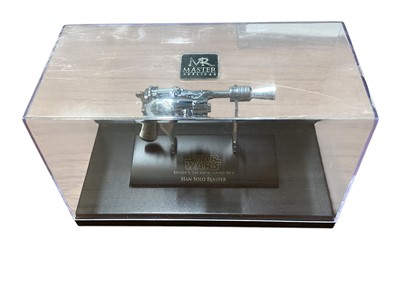 Lot 15 - Star Wars Master Replica Episode IV: A New Hope small scaled Stormtrooper Blaster & Episode V:The Empire Strikes Back Han Solo Blaster, both in display cases