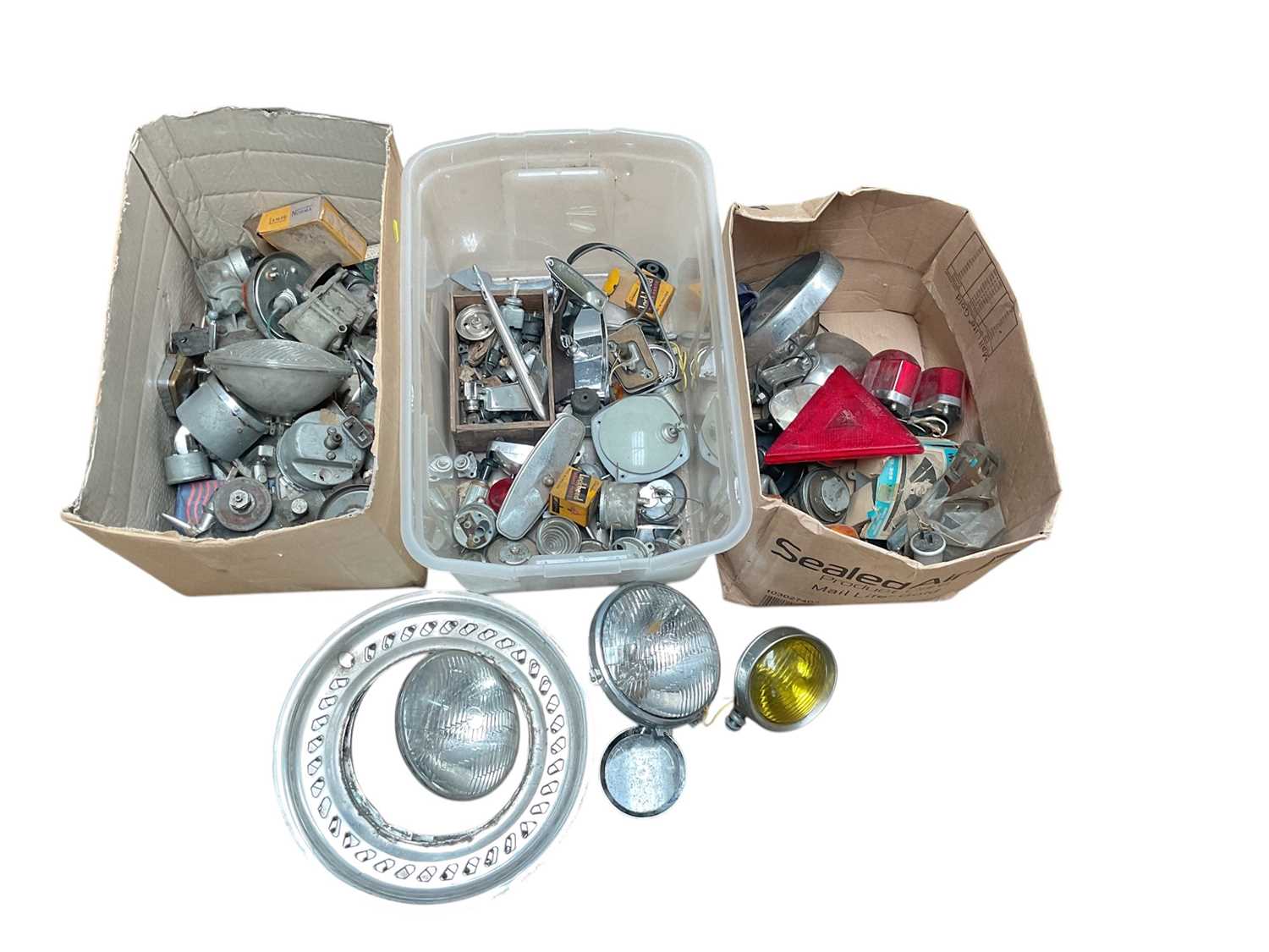 Lot 20 - Three boxes of assorted classic car parts including, lights, chrome fittings and gauges, believed to be mostly Ford Cortina, together with bumpers.