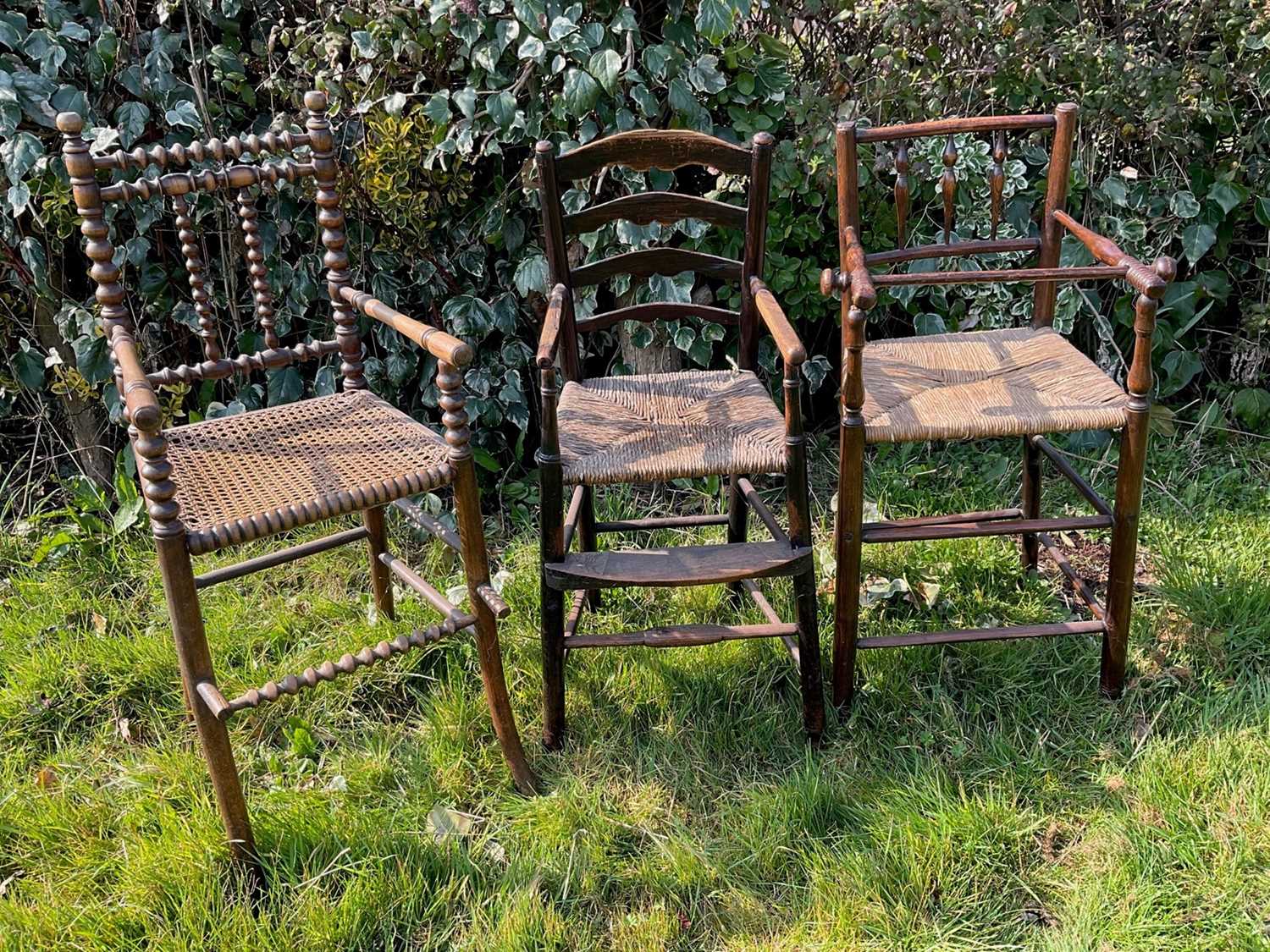 Lot 1459 - Three 19th century rustic ash and elm children's high chairs, the tallest 94.5cm high