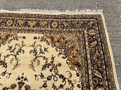 Lot 1347 - Large rug with central medallion on cream and brown ground, 280cm x 203cm