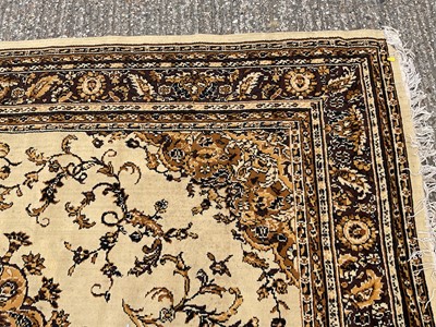 Lot 1347 - Large rug with central medallion on cream and brown ground, 280cm x 203cm
