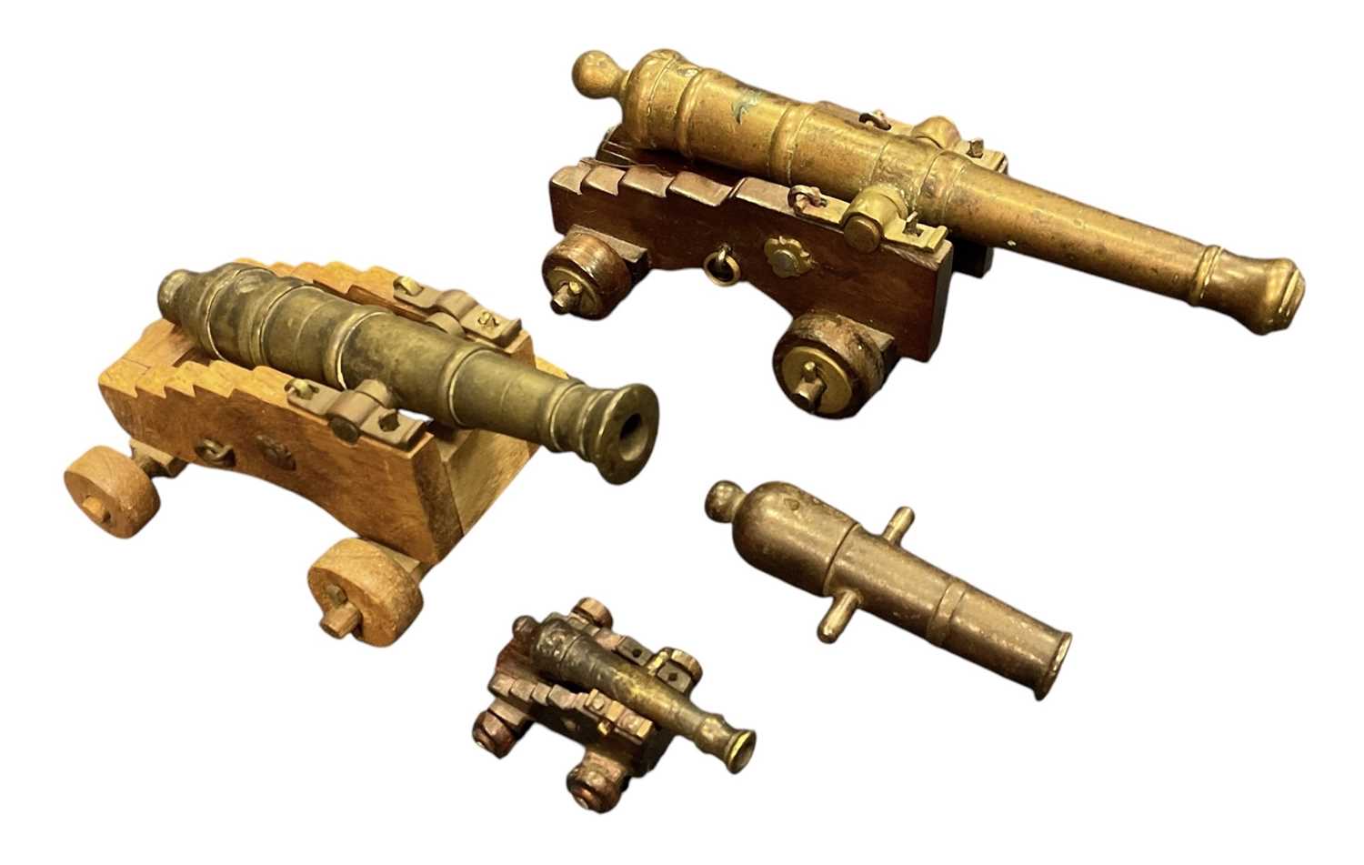 Lot 148 - Antique miniature signalling cannon on wooden gun carriage, the barrel 18.4cm in length, together with another two similar cannons and a further cannon without gun carriage (4).