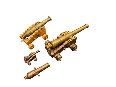 Lot 148 - Antique miniature signalling cannon on wooden gun carriage, the barrel 18.4cm in length, together with another two similar cannons and a further cannon without gun carriage (4).