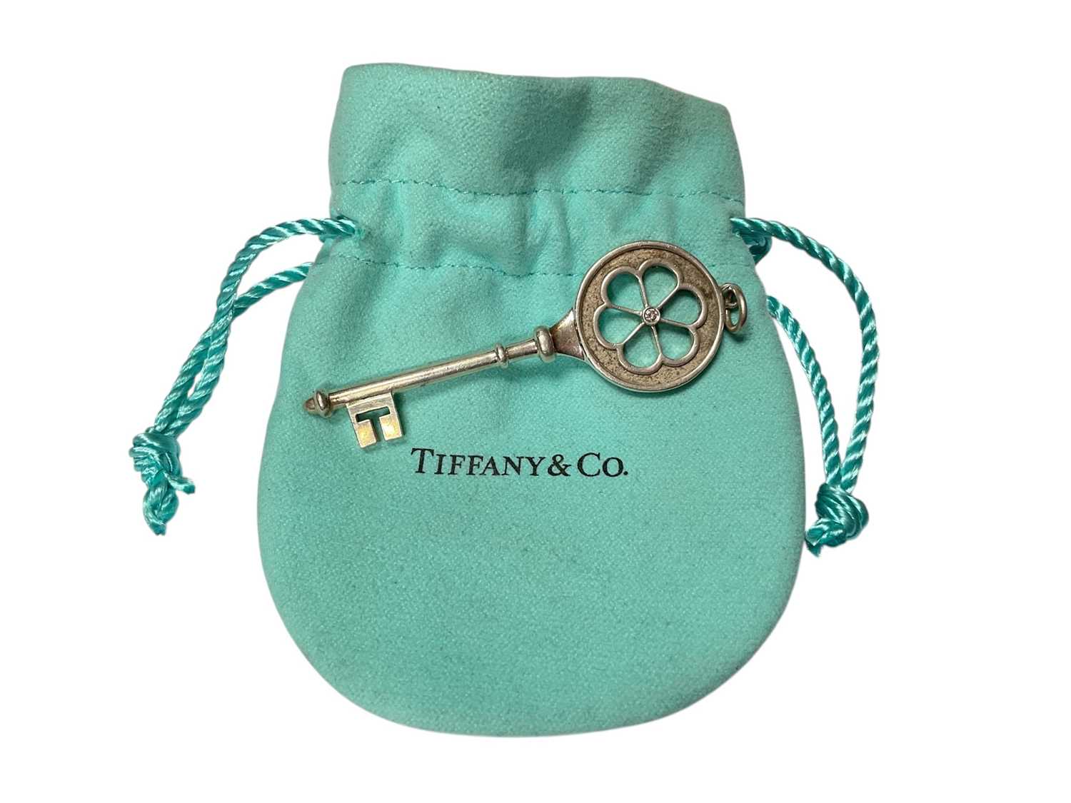 Lot 10 - Tiffany & Co silver daisy diamond set key pendant in pouch