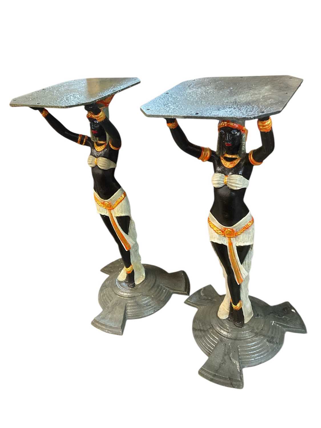 Lot 918 - Pair of Art Deco style cast iron table pedestals, with Egyptian figural supports on stepped spread base, 71cm high