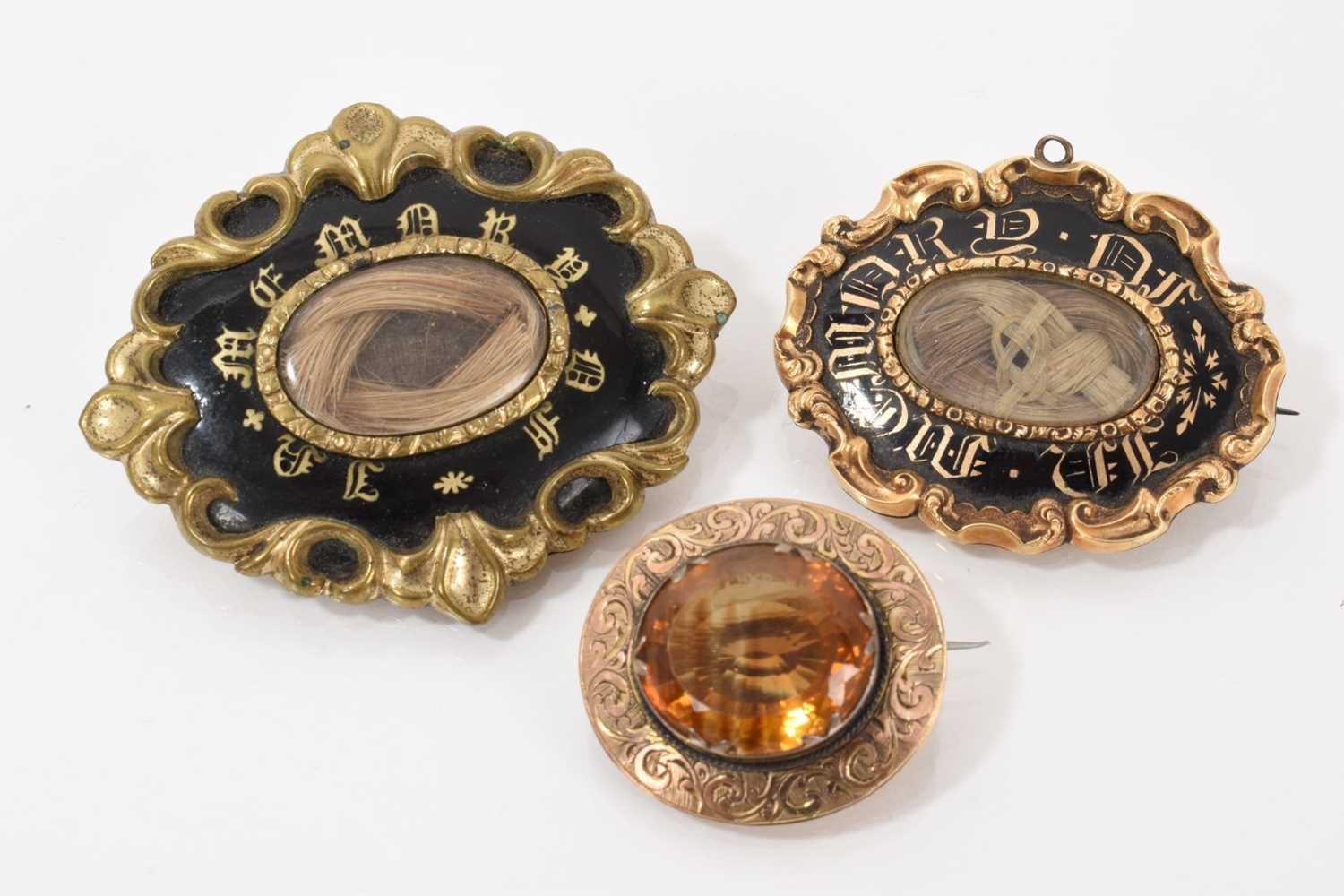 Lot 508 - Two early Victorian mourning brooches and a Victorian citrine/cairngorm brooch (3)