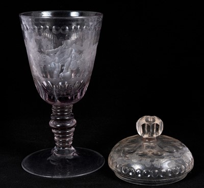 Lot 26 - Large Bohemian cut and engraved glass goblet and domed cover, circa 1730, well engraved with five putti around the body struggling with a heavy swag of pomegranates, grapes and other fruit, be...