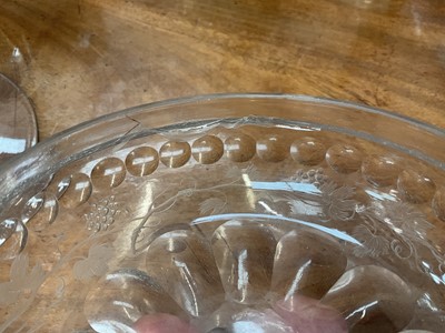 Lot 26 - Large Bohemian cut and engraved glass goblet and domed cover, circa 1730, well engraved with five putti around the body struggling with a heavy swag of pomegranates, grapes and other fruit, be...