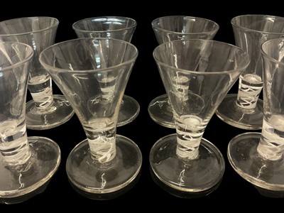 Lot 25 - Set of eight short firing glasses, 20th century, with trumpet bowls and double series opaque twist stems, 10cm high (8)