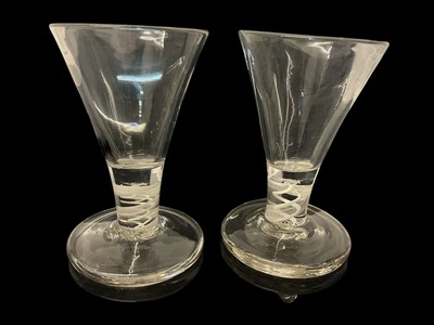 Lot 25 - Set of eight short firing glasses, 20th century, with trumpet bowls and double series opaque twist stems, 10cm high (8)