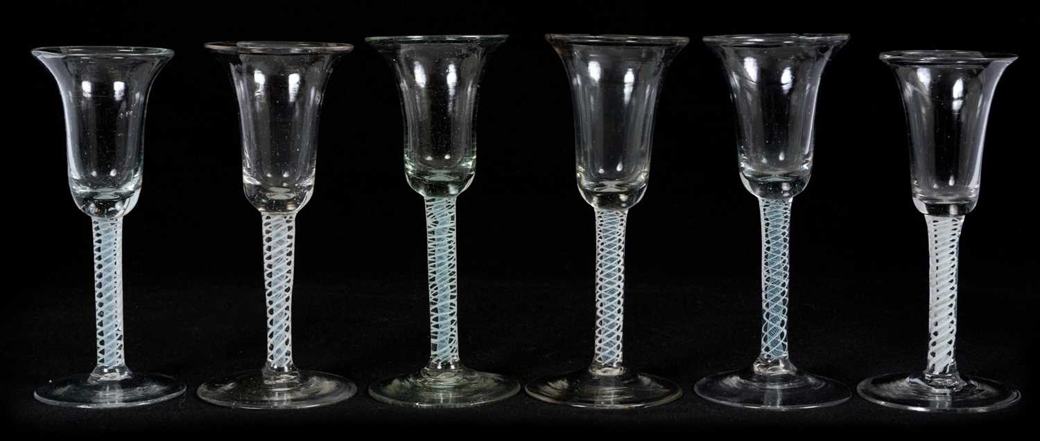 Lot 23 - Group of six wine glasses, Low Countries, circa 1760, with bell bowls on straight double series opaque twist stems, 16cm to 16.5cm high